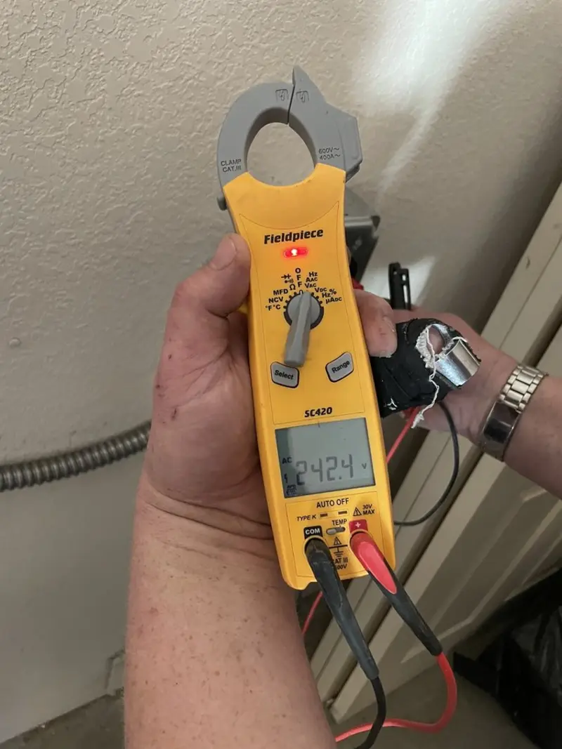 Voltage testing with clamp meter during Recessed Lighting Installation in Boston